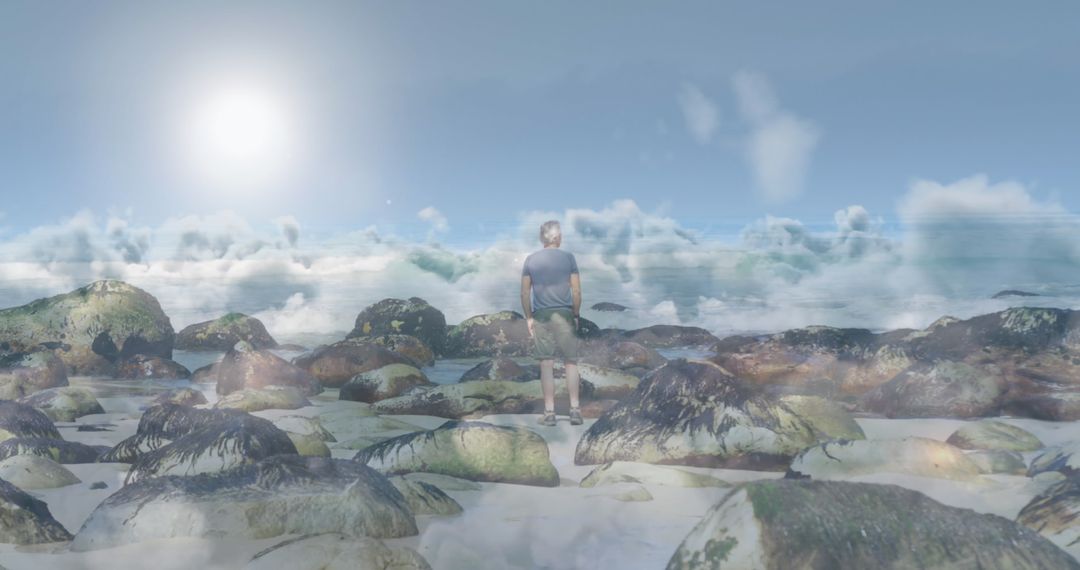 Senior Man Standing on Rocky Beach Viewed Through Surreal Moving Clouds