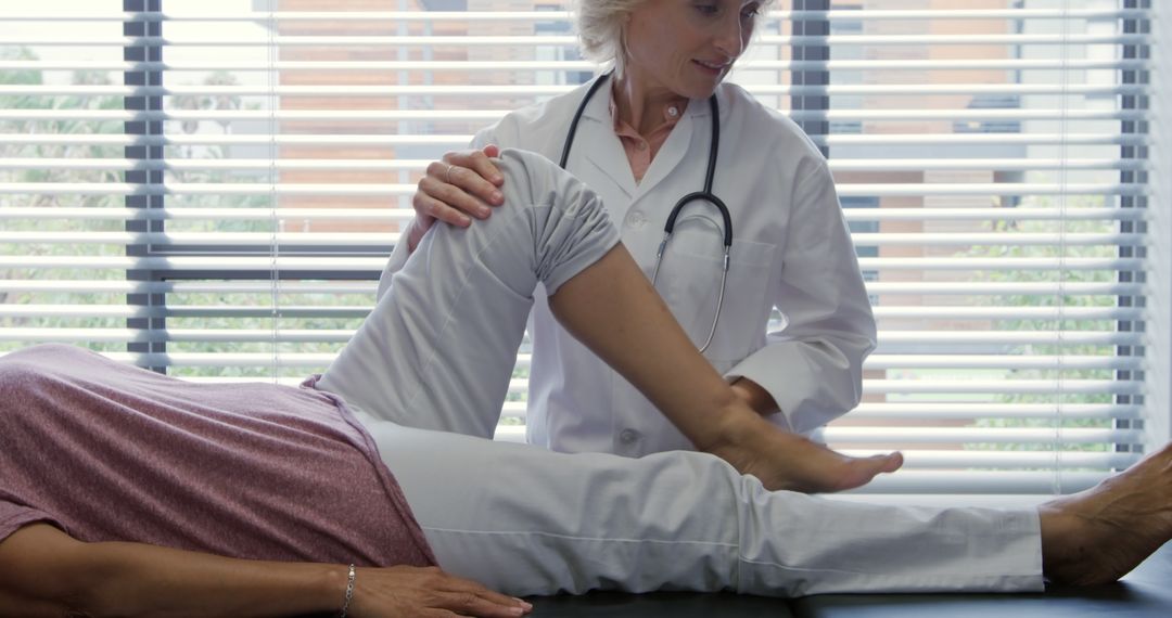 Doctor Performing Leg Examination on Patient in Clinic - Free Images, Stock Photos and Pictures on Pikwizard.com