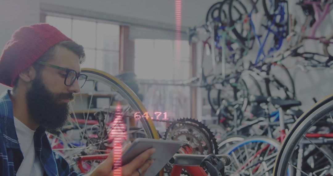 Bearded Bicycle Mechanic Using Tablet in Workshop