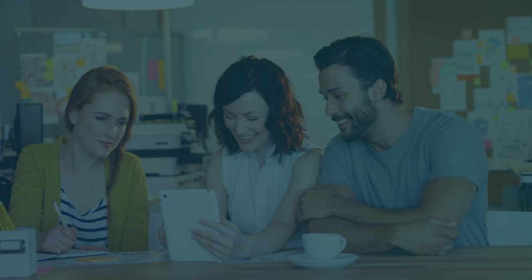 Collaborative Team Engaged in Creative Work Using Tablet in Modern Office