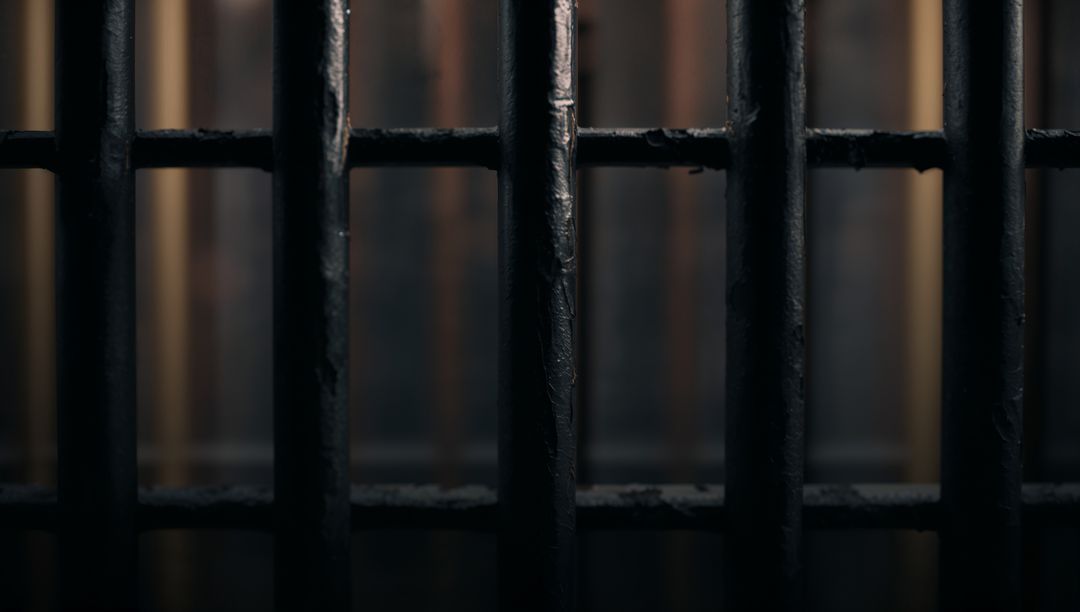 Dimly Lit Prison Bars Connoting Confinement and Isolation
