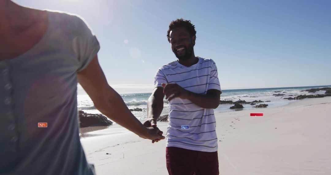 Joyful Couple Walking Hand-in-Hand on Sunny Beach Front