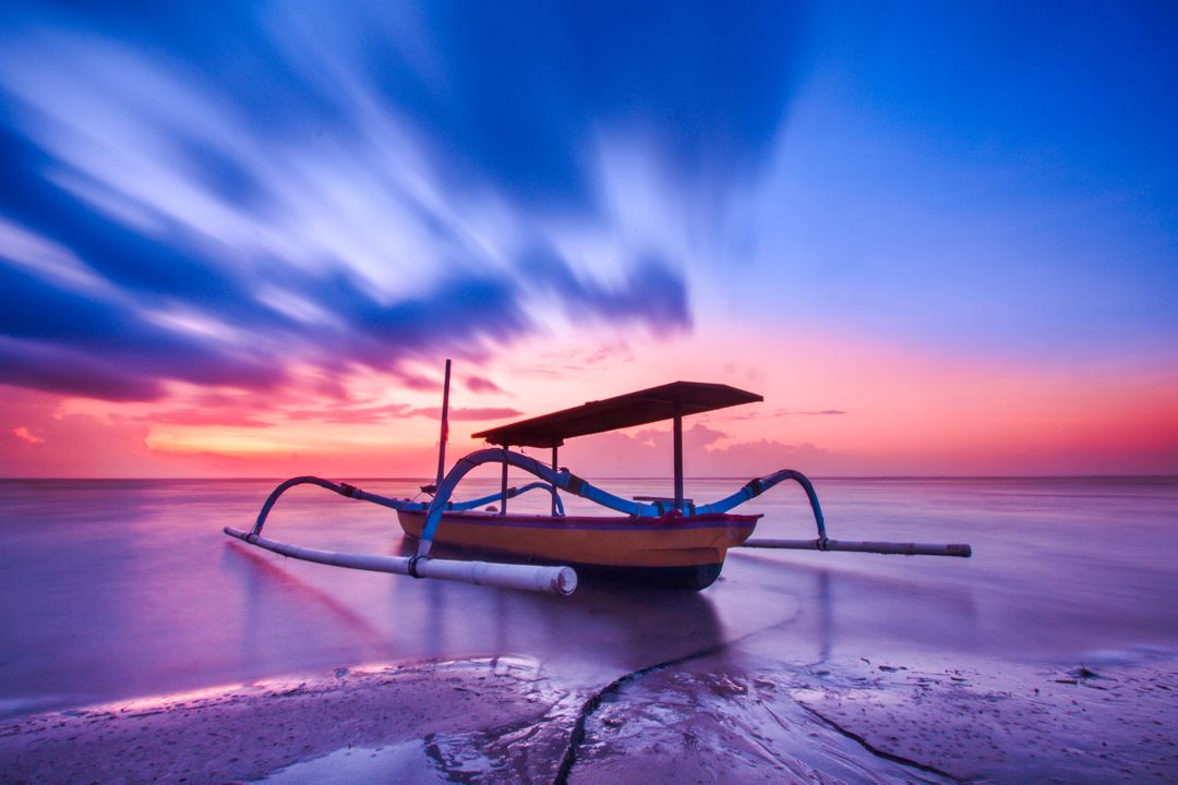 Traditional Fishing Boat at Sunset with Long Exposure Clouds - Free Images, Stock Photos and Pictures on Pikwizard.com