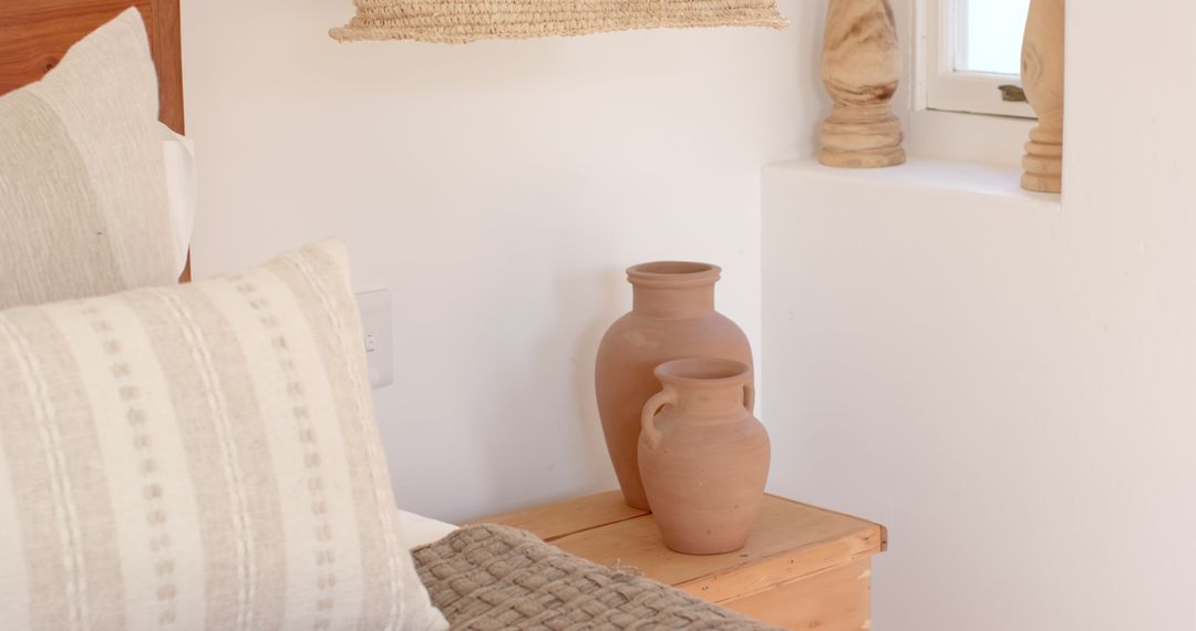 Rustic Minimalist Bedroom Decor with Terracotta Vases and Textured Elements