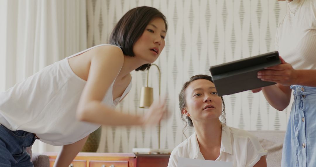 Two Women Engaging in Modern Technology Discussion Scene