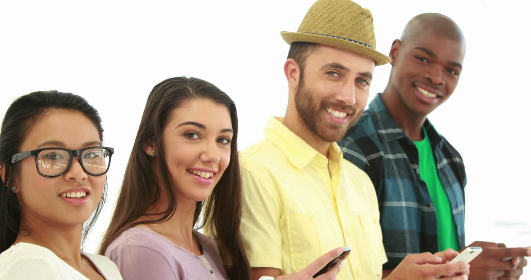 Group of Young Adults Smiling and Using Smartphones - Free Images, Stock Photos and Pictures on Pikwizard.com