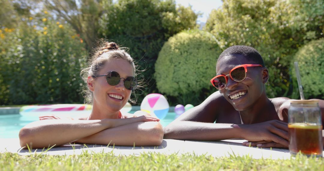 Diverse Couple Relaxing by Pool, Enjoying Sunny Day