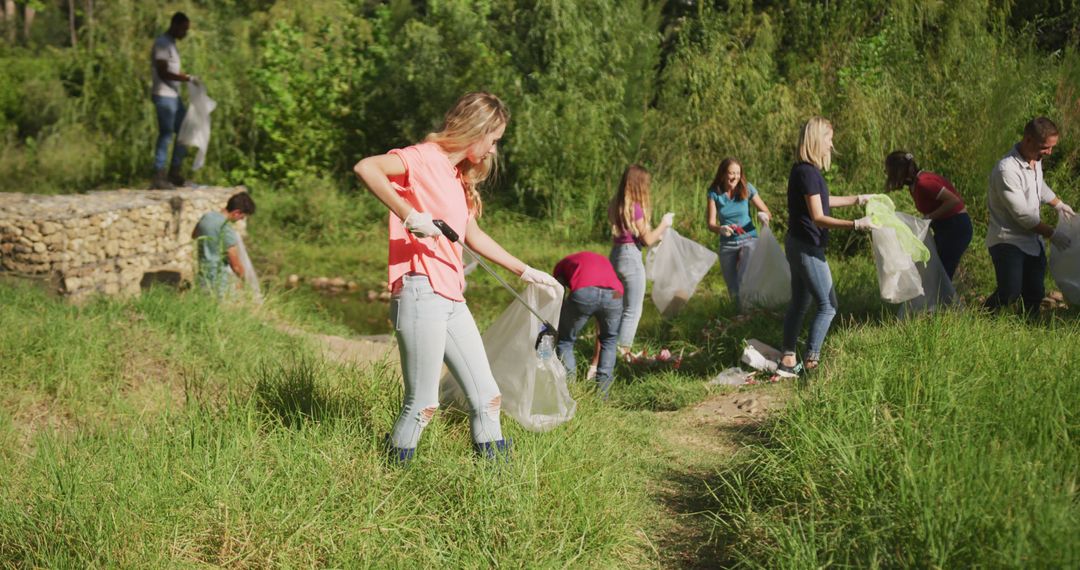 Volunteers Engaged in River Clean-Up on Sunny Day in Countryside - Free Images, Stock Photos and Pictures on Pikwizard.com