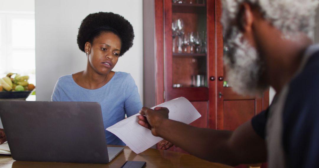 Couple Reviewing Financial Documents at Home - Free Images, Stock Photos and Pictures on Pikwizard.com