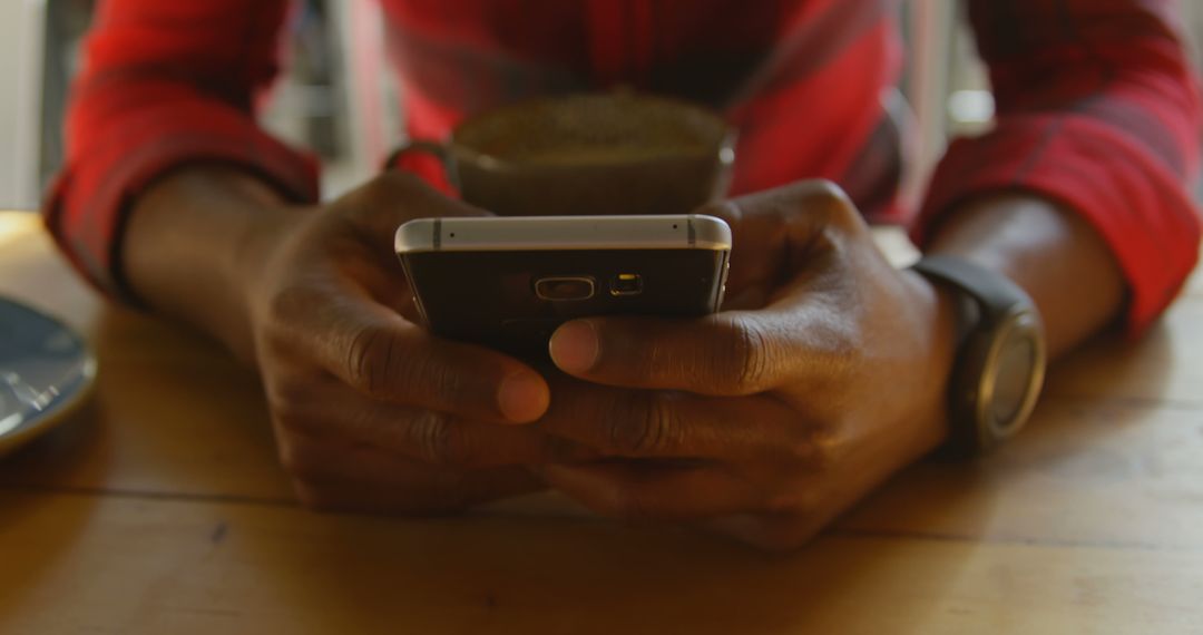 Close-Up of Man Using Smartphone While Drinking Coffee - Free Images, Stock Photos and Pictures on Pikwizard.com