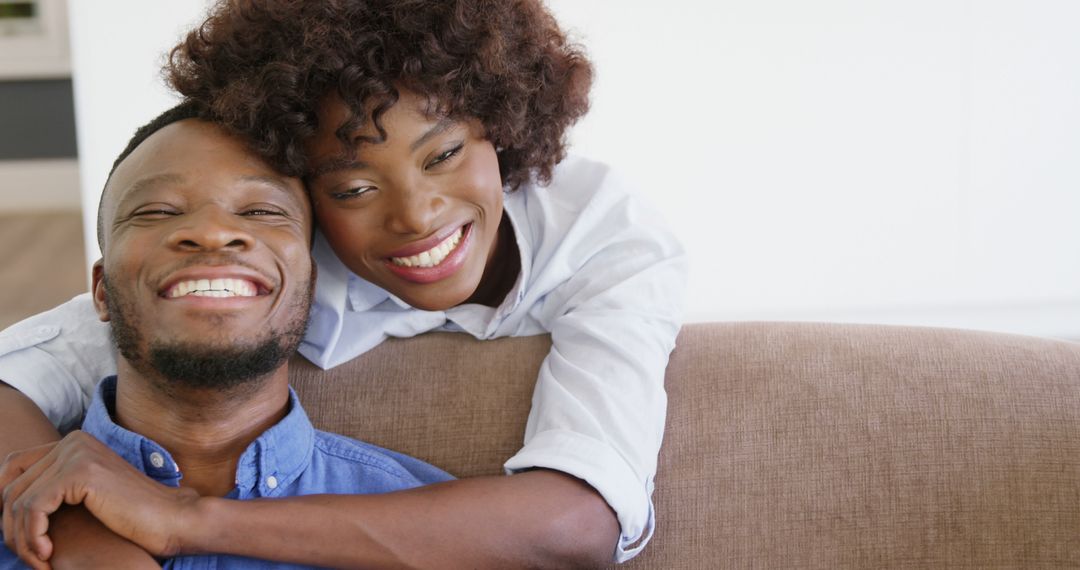 Happy Couple Embracing on Couch at Home