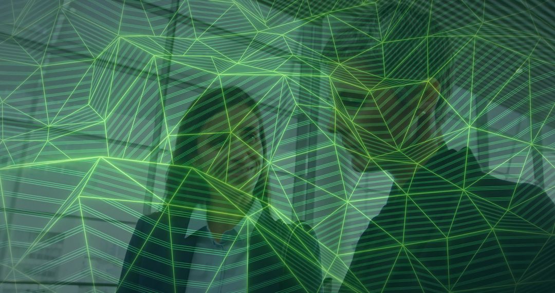 Businesswomen collaborating under green digital mesh overlay representing teamwork and tech