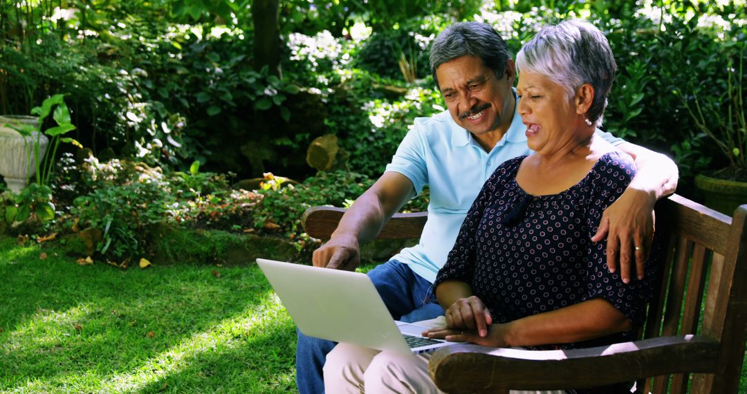 Happy Senior Couple Using Laptop in Garden - Free Images, Stock Photos and Pictures on Pikwizard.com