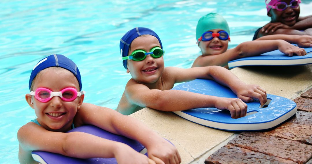 Smiling Children Learning to Swim with Kickboards in Swimming Pool - Free Images, Stock Photos and Pictures on Pikwizard.com