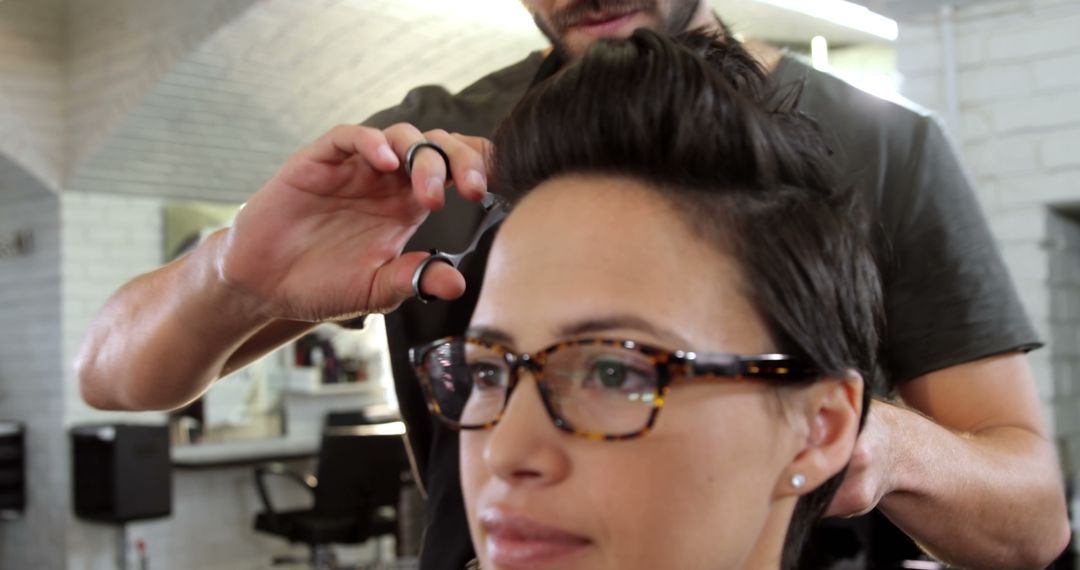 A young Caucasian woman is getting a haircut from a hairstylist, with copy space - Free Images, Stock Photos and Pictures on Pikwizard.com