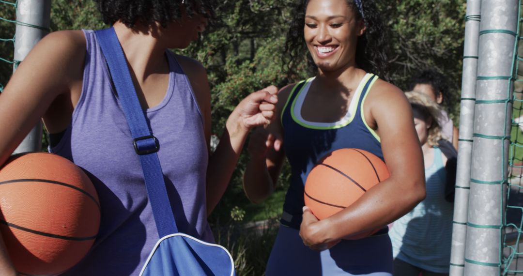 Two female friends playing basketball outdoors - Free Images, Stock Photos and Pictures on Pikwizard.com