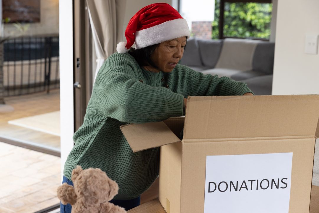 Senior Woman Sorting Donations During Holidays for Generosity and Sharing