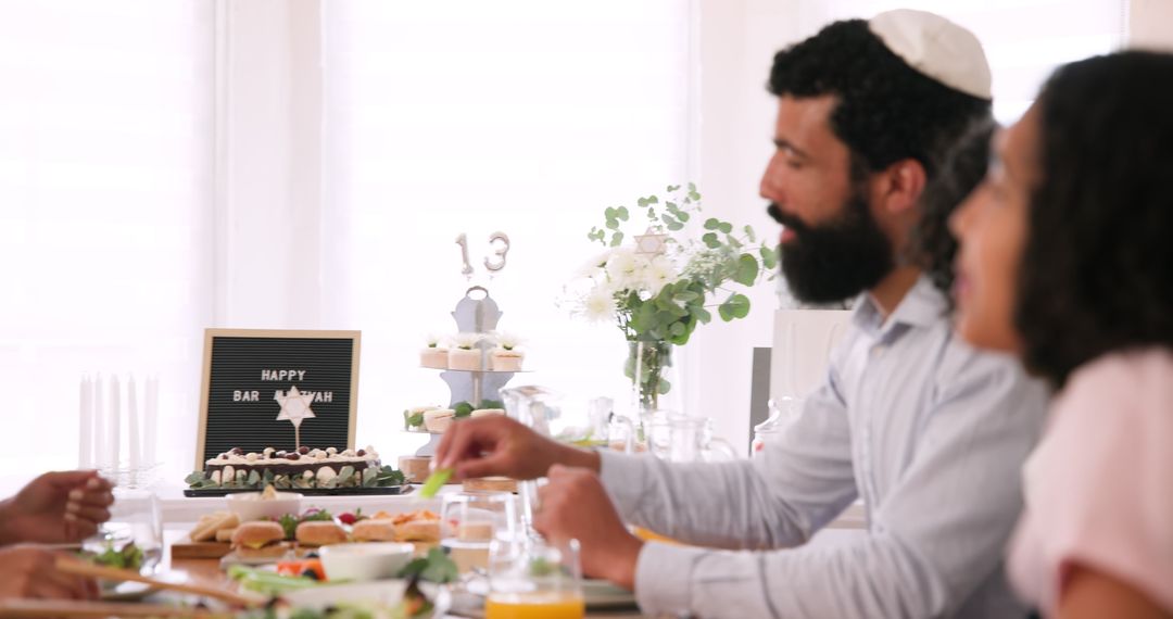 Family Celebrating Bar Mitzvah At Shared Dining Table