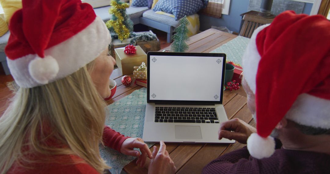 Couple Enjoying Christmas Together with Laptop Surprise Inside Cozy Home - Free Images, Stock Photos and Pictures on Pikwizard.com