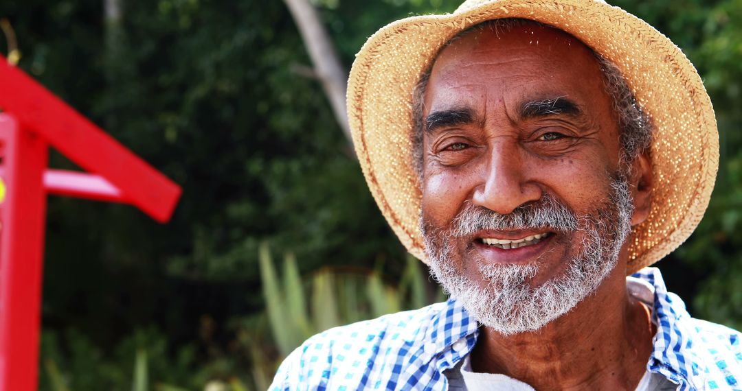 Smiling Elderly Man in Straw Hat Enjoying Nature Outdoors - Free Images, Stock Photos and Pictures on Pikwizard.com