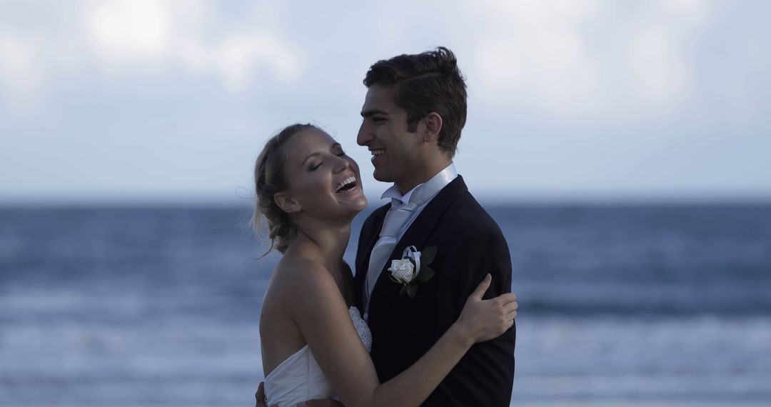 Newlywed Couple Embracing on Beach at Sunset - Free Images, Stock Photos and Pictures on Pikwizard.com