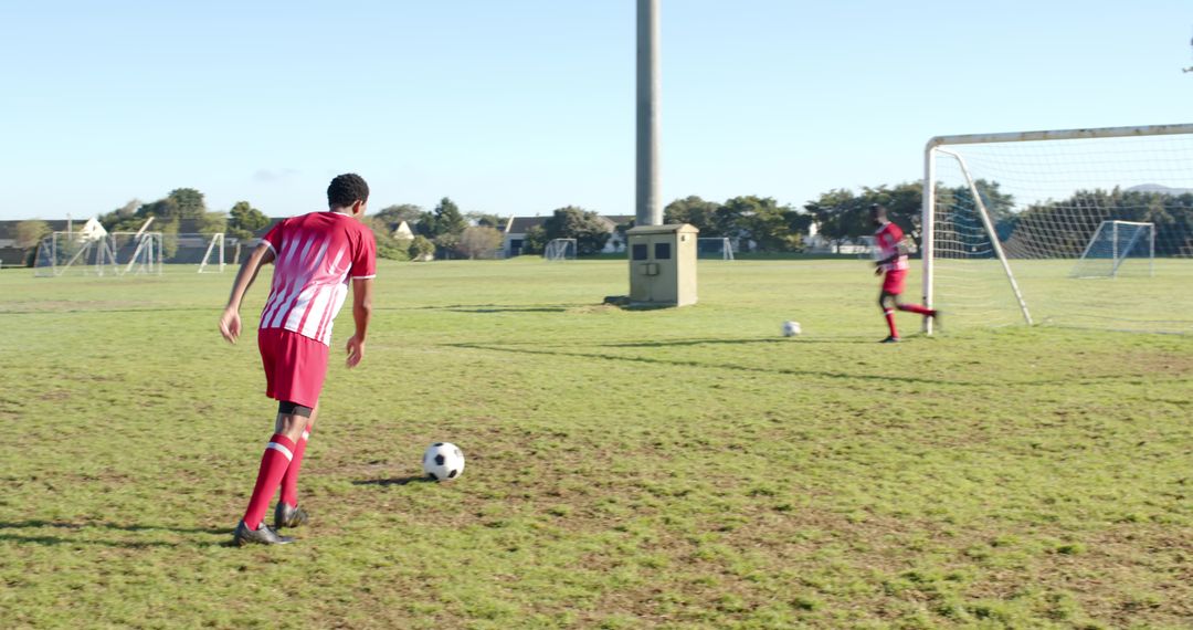 Teammates Practicing Soccer Skills in Park On Sunny Day