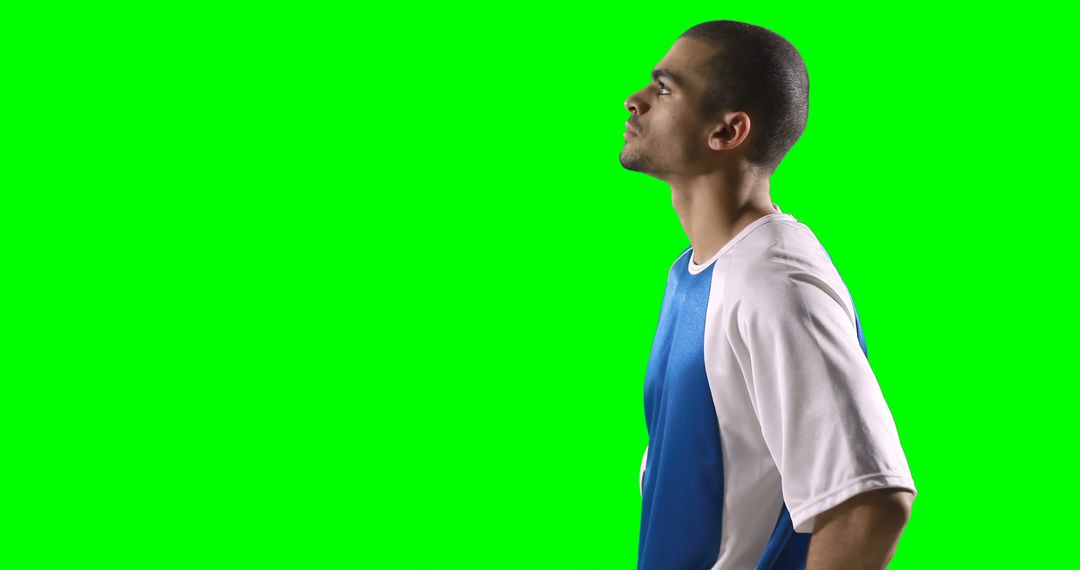 Young Athlete in Blue and White Jersey Posing Against Green Screen - Free Images, Stock Photos and Pictures on Pikwizard.com