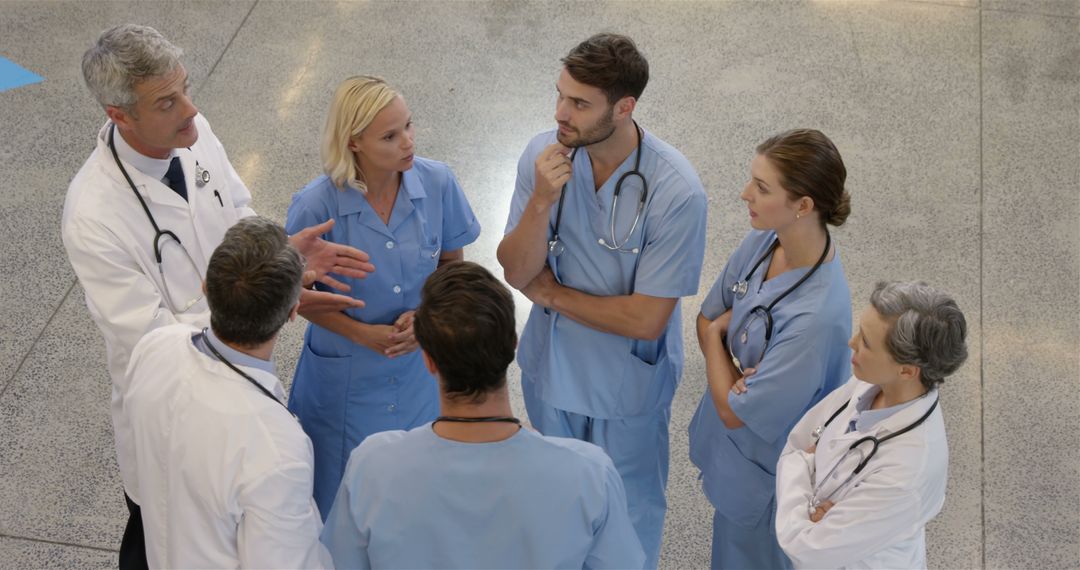 Medical Team in Discussion in Hospital Lobby - Free Images, Stock Photos and Pictures on Pikwizard.com