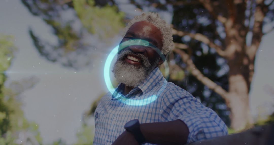 Senior Man Smiling in Sunlit Garden Leaning on Railing