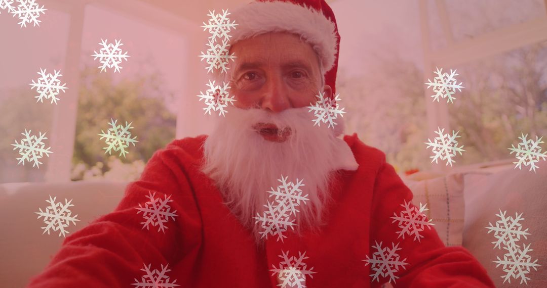 Festive Man in Santa Costume with Falling Snowflakes on Video Call