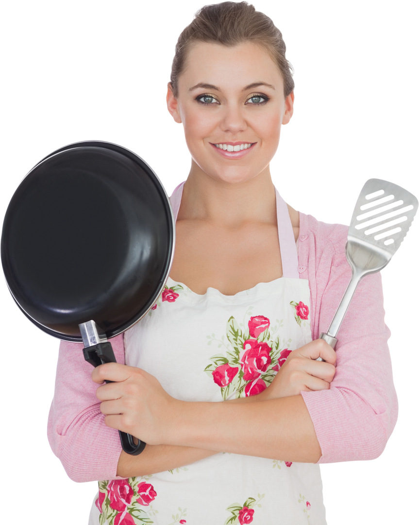 Smiling Woman Holding Frying Pan and Spatula in Floral Apron - Download Free Stock Images Pikwizard.com