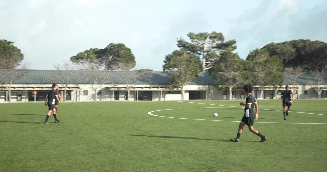 Soccer Referees walking during Player Warm-ups on Green Field