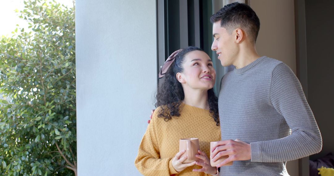 Romantic Couple Enjoying Coffee by Sliding Glass Door
