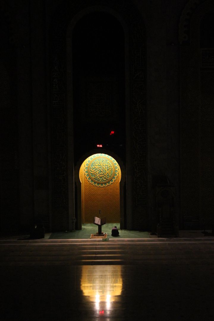 Solitary Person Praying in Dimmly Lit Mosque - Free Images, Stock Photos and Pictures on Pikwizard.com