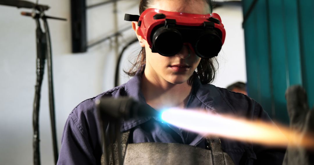 Young Female Technician Handling Blowtorch in Workshop - Free Images, Stock Photos and Pictures on Pikwizard.com