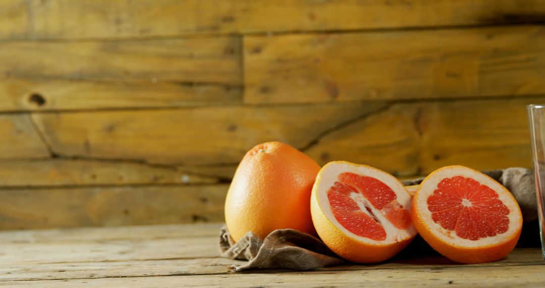 Fresh Grapefruit Halves on Rustic Wooden Table - Free Images, Stock Photos and Pictures on Pikwizard.com