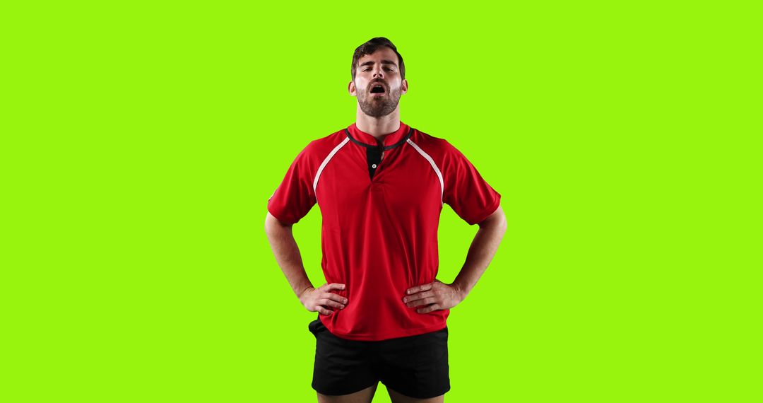 Exhausted Male Athlete in Red Sportswear Standing Against Green Background - Free Images, Stock Photos and Pictures on Pikwizard.com