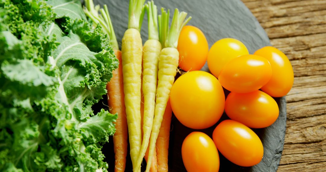 Fresh Carrots, Yellow Tomatoes, and Kale on Rustic Wooden Table - Free Images, Stock Photos and Pictures on Pikwizard.com