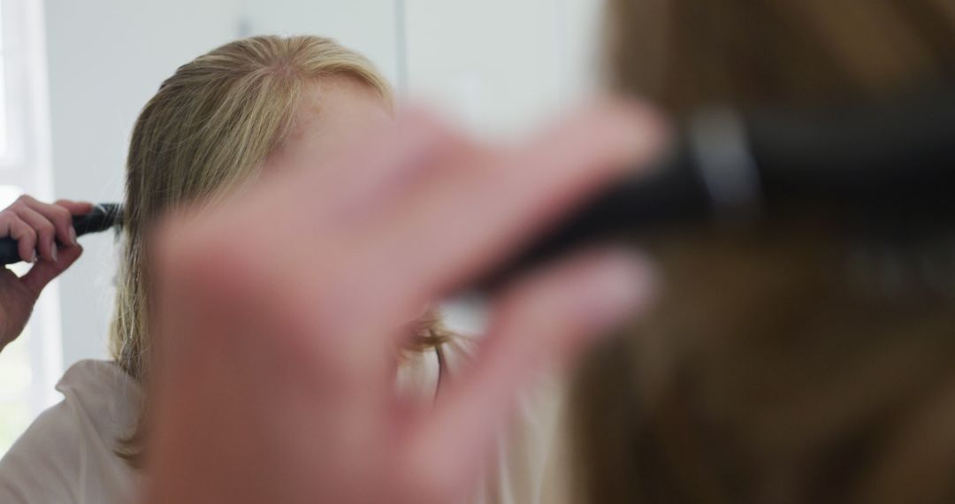 Person Combing Hair in Mirror for Morning Routine - Free Images, Stock Photos and Pictures on Pikwizard.com