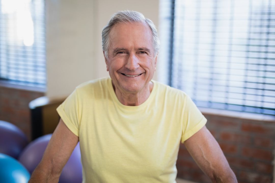 Portrait of smiling senior male patient against window - Free Images, Stock Photos and Pictures on Pikwizard.com