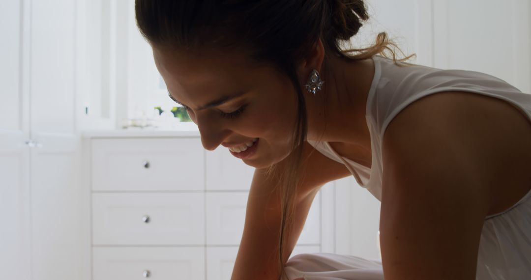 Joyful Woman Leaning in White Decor Room Celebratory Vibe - Free Images, Stock Photos and Pictures on Pikwizard.com