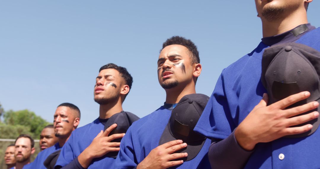 Baseball team honoring national anthem, hands on hearts - Free Images, Stock Photos and Pictures on Pikwizard.com