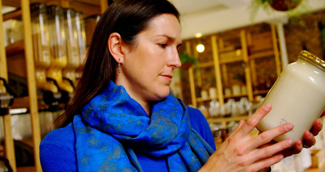 Woman Examining Product in Zero-Waste Store - Free Images, Stock Photos and Pictures on Pikwizard.com