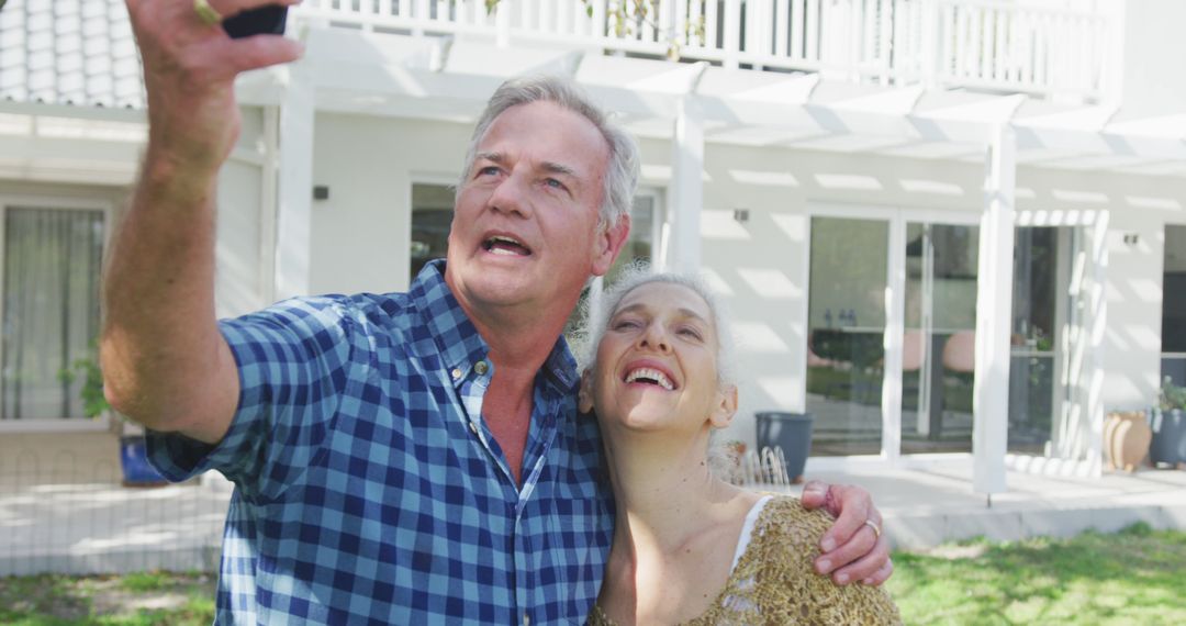 Happy caucasian senior couple taking selfie in front of house - Free Images, Stock Photos and Pictures on Pikwizard.com