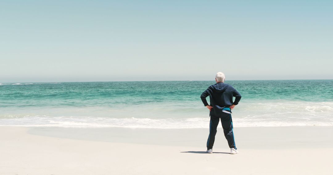 Senior Man Standing on Beach Gazing at Ocean - Free Images, Stock Photos and Pictures on Pikwizard.com