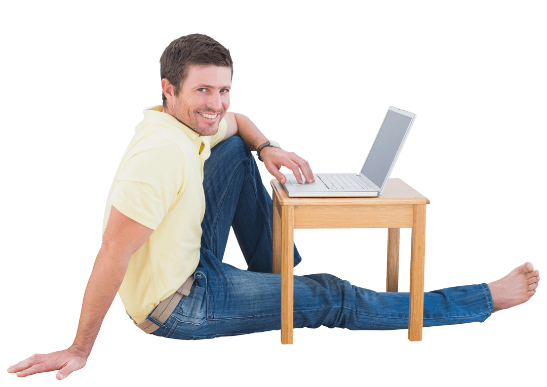 Smiling Man Sitting on Floor Using Laptop with Transparent Background