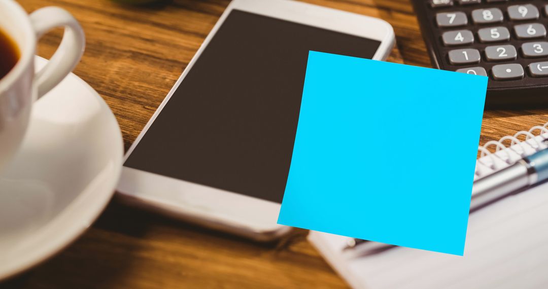 Bright Sticky Note on Desk Smartphone Suggesting Clean Desk Day