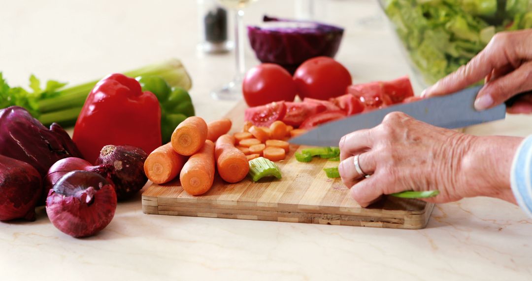 Close-Up of Person Chopping Fresh Vegetables on Wooden Cutting Board in Kitchen - Free Images, Stock Photos and Pictures on Pikwizard.com