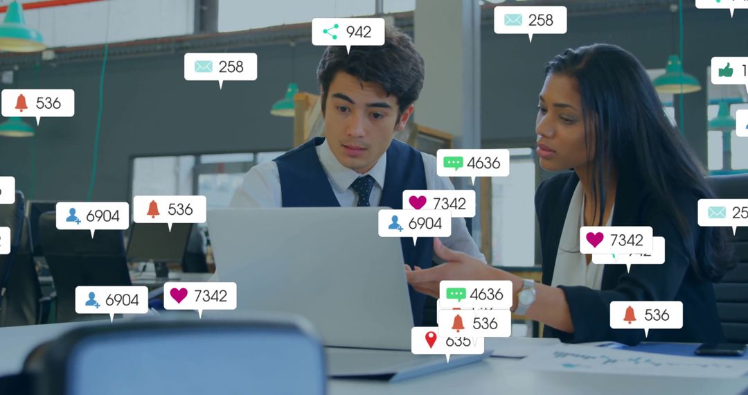 Business Team Analyzing Performance Data on Laptop in Modern Office