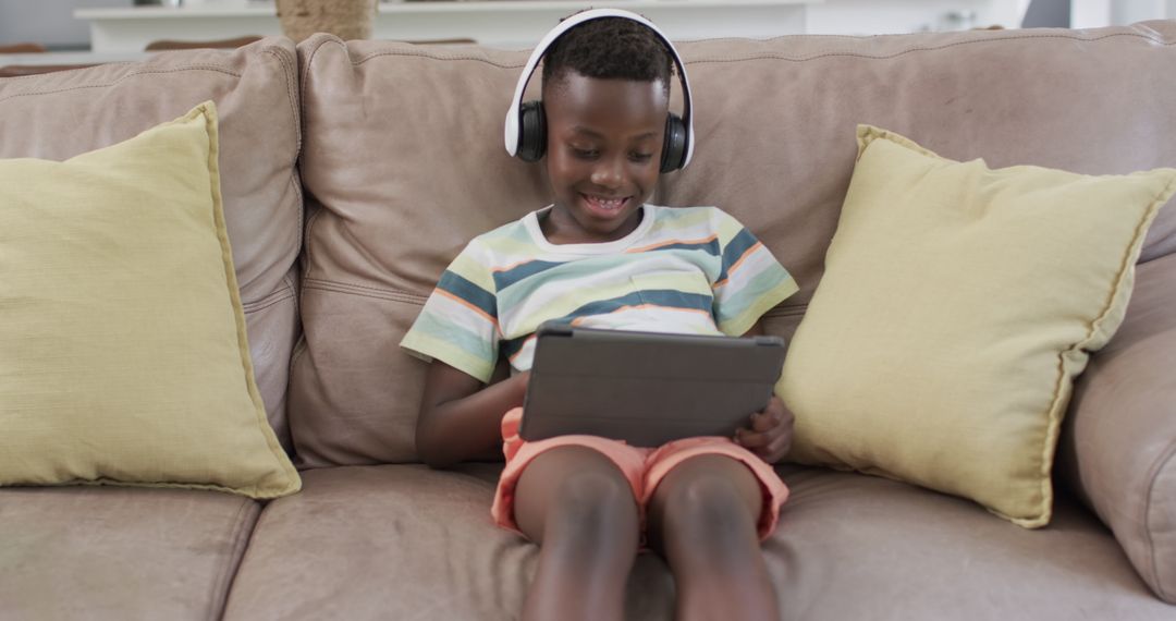 Boy Enjoying Digital Entertainment on Tablet at Home